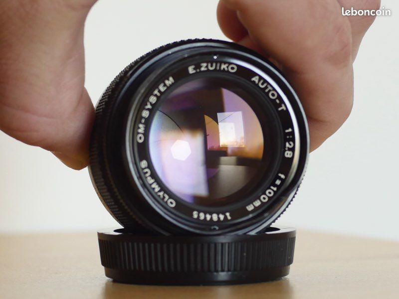 Objectif Olympus OM-System E.Zuiko Auto-T 100mm F/2.8 - NEUF (état) Avec Capot Et étui