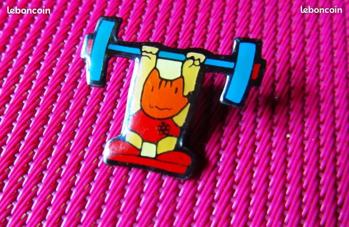 Pin's Jeux Olympiques Barcelone 1992 - Mascotte Cobi Haltérophile, édition Officielle