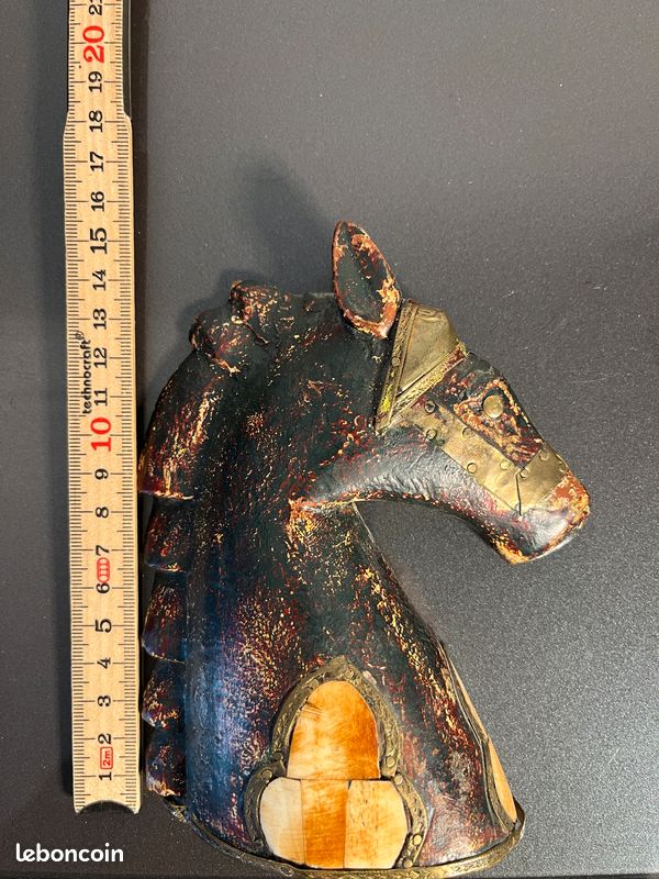 Ancienne hache en fer décorée de six têtes. Manche en bois dur laqué