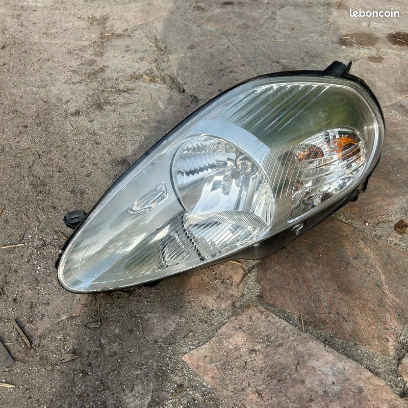 Optique avant principal gauche (feux) (phare) d'occasion Fiat GRANDE PUNTO